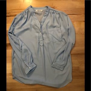 Light blue polyester shirt, size medium.